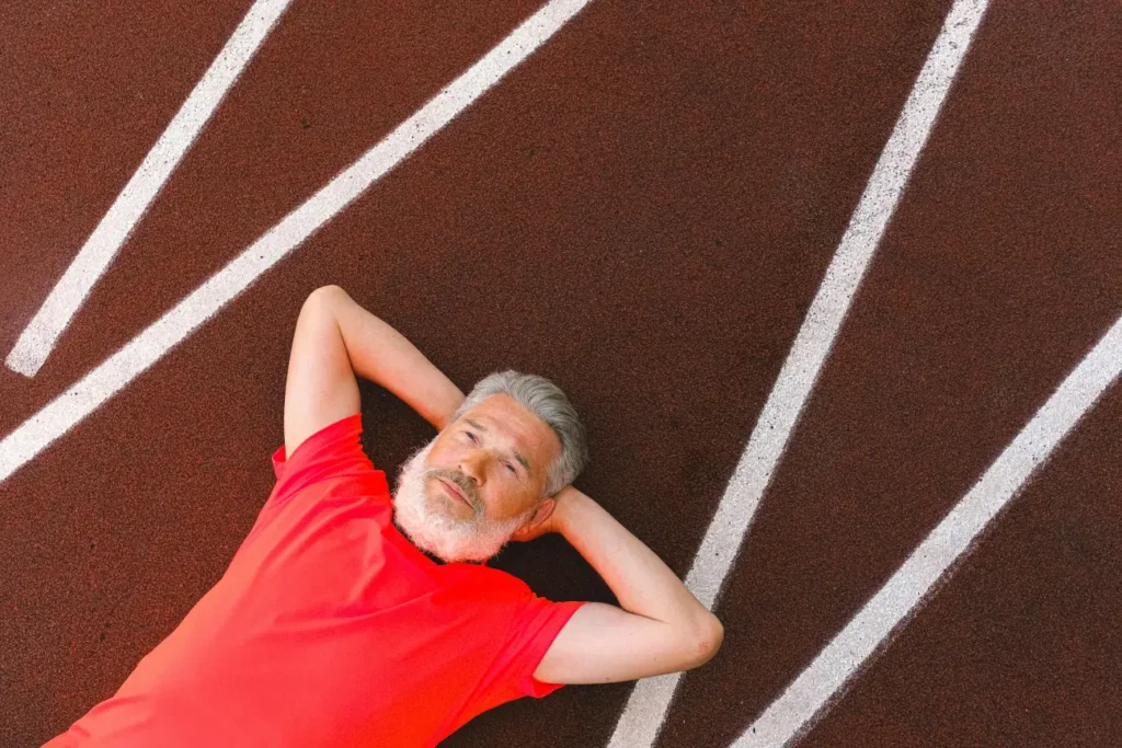 Senior man with beard resting peacefully on racetrack